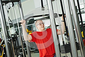 Man doing back exercises at fitness gym