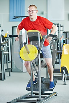 Man doing back exercises at fitness gym