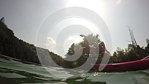 Man doing backflip from canoe into water