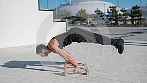 Man doing balance exercise on floor bars for fitness.