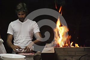 Man doing a barbecue by night