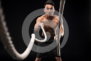 man doing battle ropes exercise
