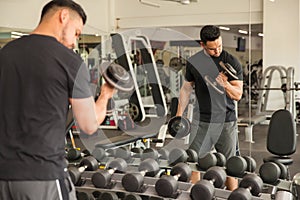 Man doing bicep curls in front of a mirror