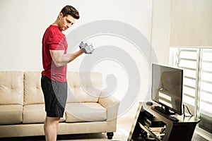 Man doing bicep curls at home