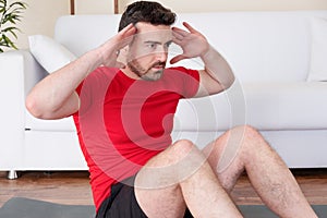 Man doing body exercise and working out at home