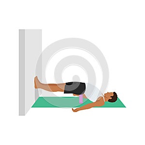 Man doing bridge pose setu bandha sarvangasana to the wall exercise.