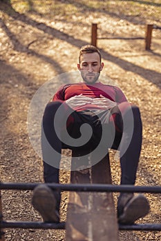 Man doing crunches in street workout park
