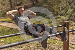 Man doing crunches in street workout park