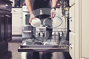 Man doing dishes cleaning in the kitchen household chores