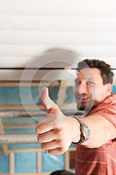 Man doing dry walling, working