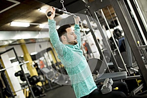 Man doing excersise on a lat machine in gym