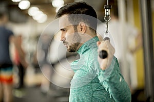 Man doing excersise on a lat machine in gym