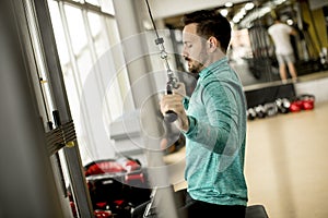 Man doing excersise on a lat machine in gym