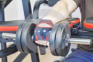 Man doing exercise with dumbbell for forearms