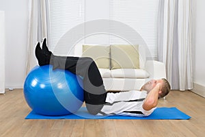Man Doing Exercise With A Pilates Ball