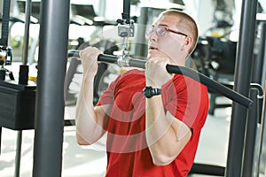 Man doing exercises at fitness gym