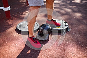 A man is doing exercises on his feet. Sporty and healthy young man with perfect body exercising outdoors.