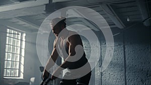 Man doing fitness workout with battle ropes. Guy performing sport exercise