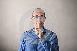 Man doing the gesture of silencing