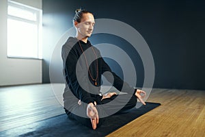 Man doing gyan mudra and pranayama. Yoga practice in the studio.