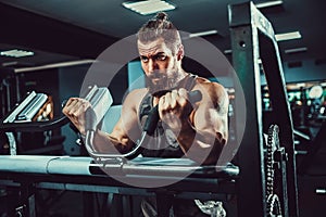 Man Doing Heavy Weight Exercise For Biceps On Machine In A Gym