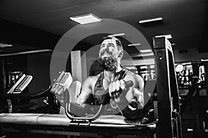 Man Doing Heavy Weight Exercise For Biceps On Machine In A Gym