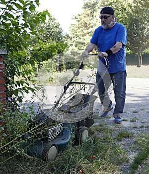 A man doing his duty: mowing grass