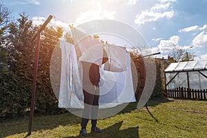 Man doing household chores and hanging the laundry