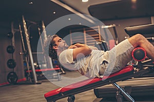 Man doing incline bench sit ups