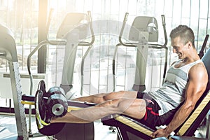 Man doing leg extension in gym