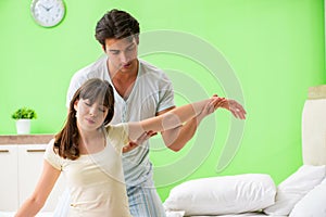 The man doing massage to his wife in bedroom