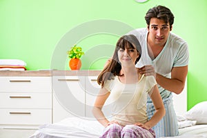 The man doing massage to his wife in bedroom