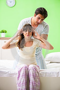 The man doing massage to his wife in bedroom