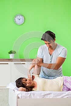 The man doing massage to his wife in bedroom