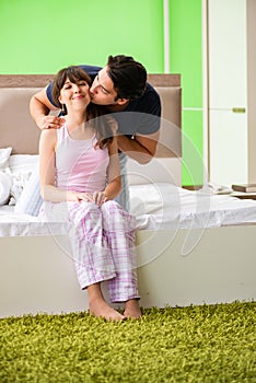 The man doing massage to his wife in bedroom