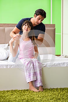 The man doing massage to his wife in bedroom