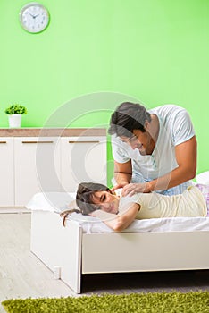 The man doing massage to his wife in bedroom