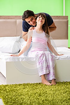 The man doing massage to his wife in bedroom