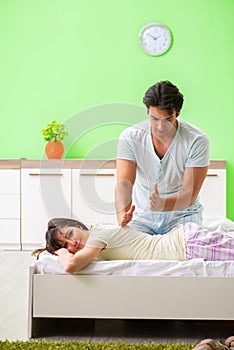 The man doing massage to his wife in bedroom