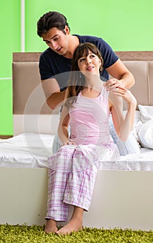 Man doing massage to his wife in bedroom