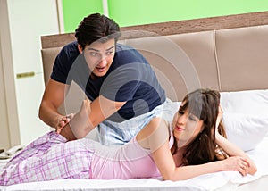 Man doing massage to his wife in bedroom