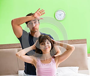 Man doing massage to his wife in bedroom