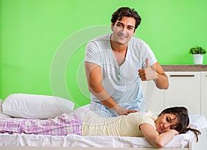 Man doing massage to his wife in bedroom