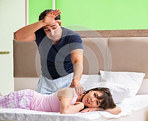 Man doing massage to his wife in bedroom