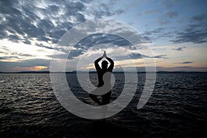 Man doing morning exercises by the sea, Silhouette