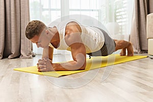 Man doing plank during intense home workout