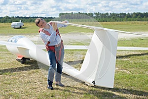 Man doing preflight check around glider