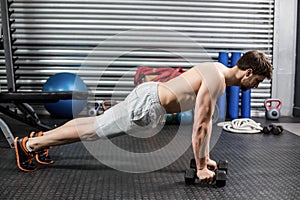 Man doing push up with dumbells