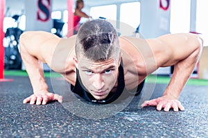 Man doing push-up in sport fitness gym