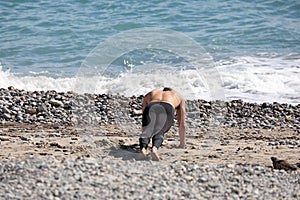 Man Doing Push Ups At The Beach